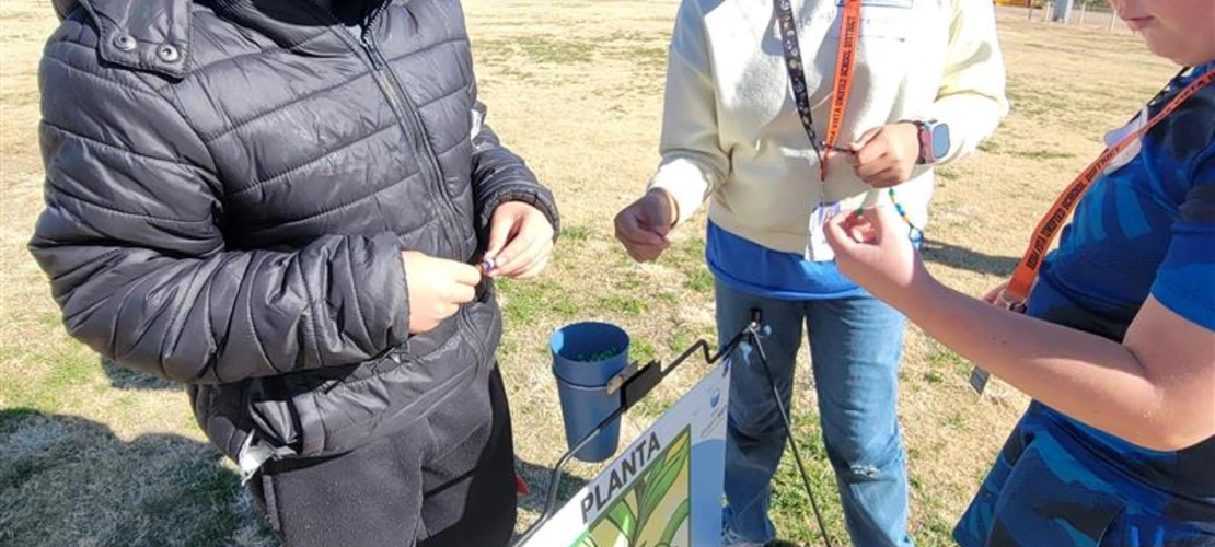 students collecting beads on their water cycle journey