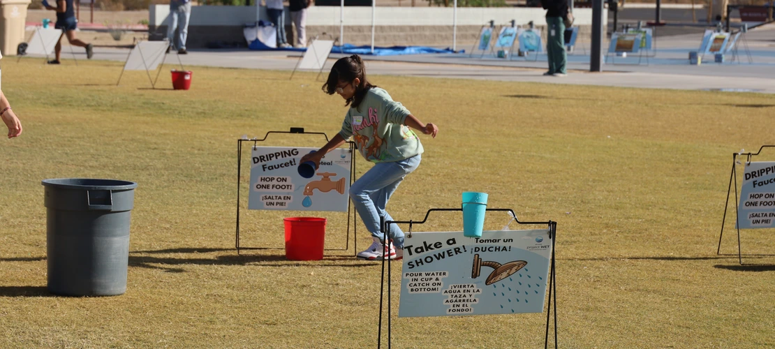 student running relay game at water festival