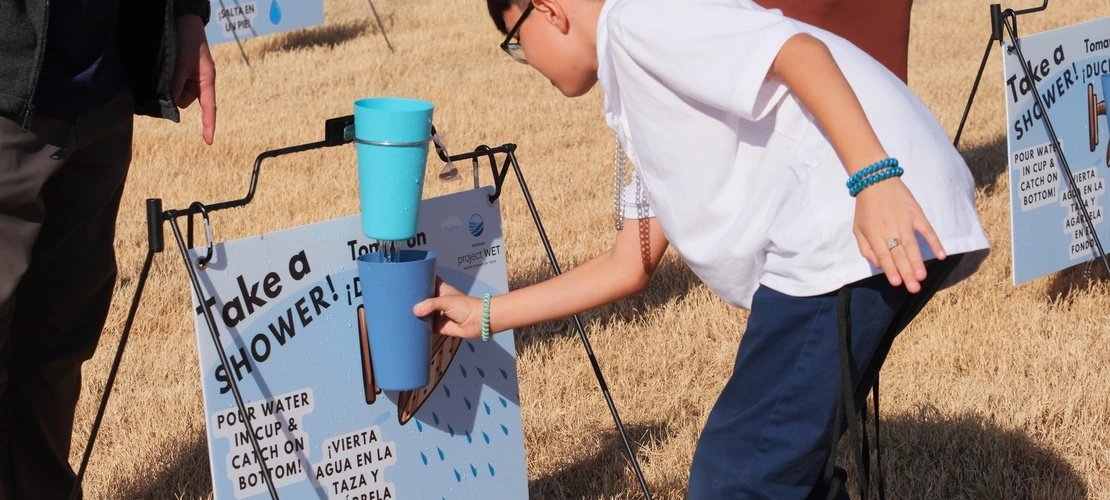 Student catching water at a shower game 