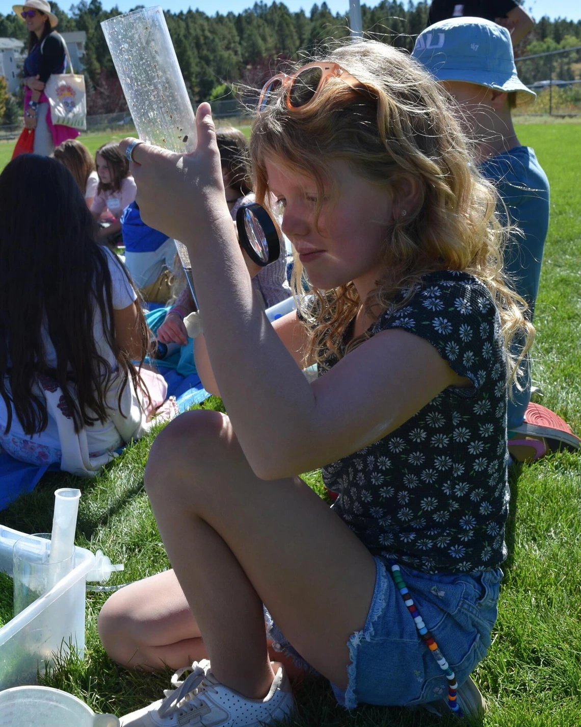 student inspecting earth materials in a tube