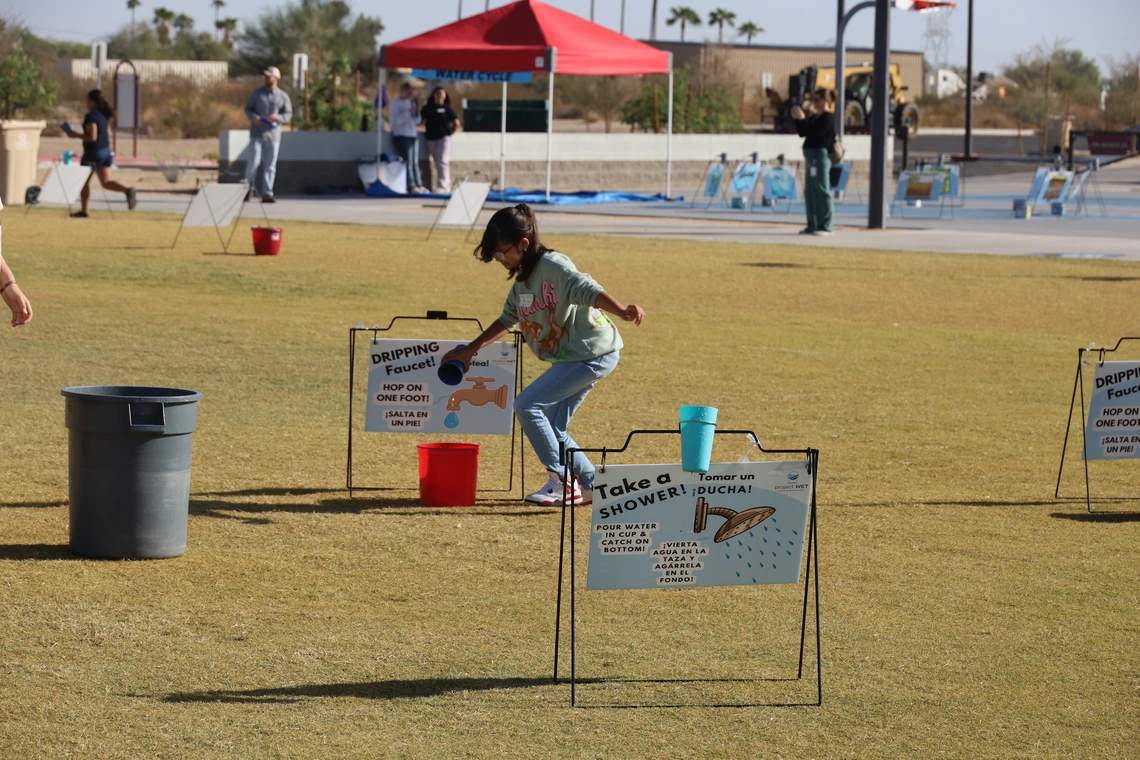 student running relay game at water festival
